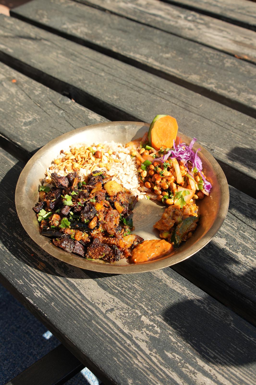 Traditional Nepalese buff sukuti khaja set on a brass plate