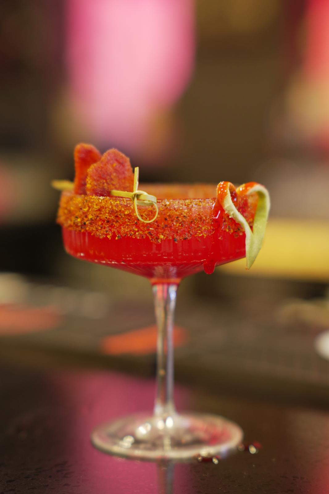 Titaura Lali cocktail with chili-spiced rim and lime twist